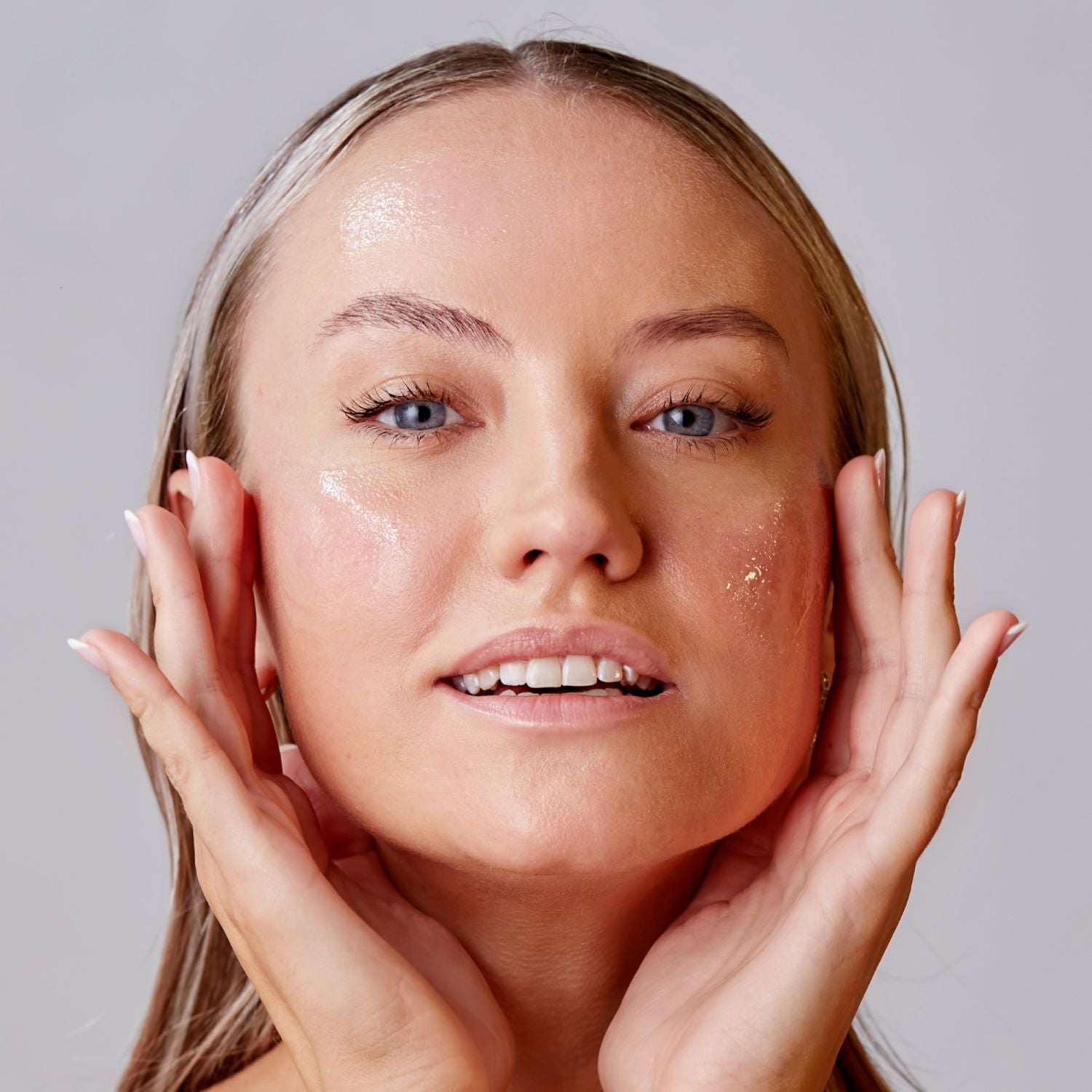 Woman applying serum to face antipodes